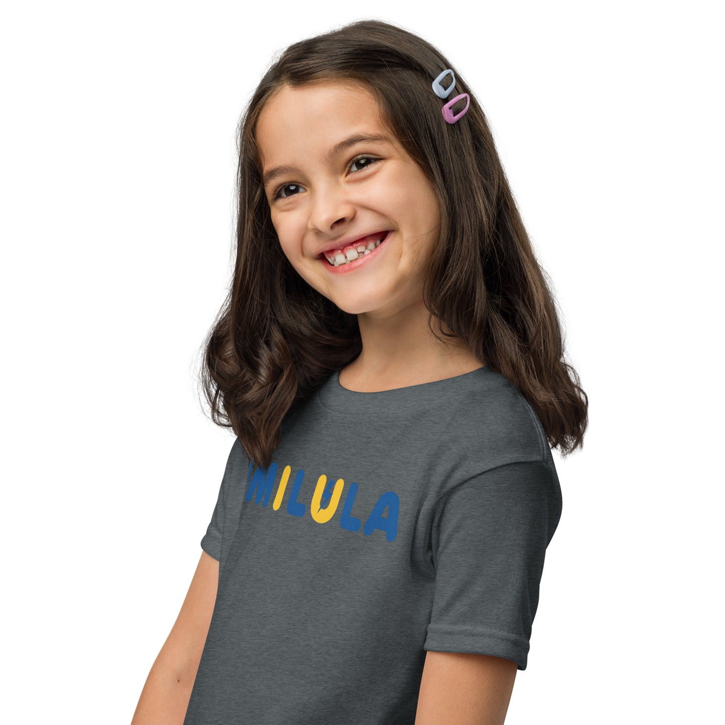 Young girl wearing a gray t-shirt with 'MIULA' printed on it against a white background