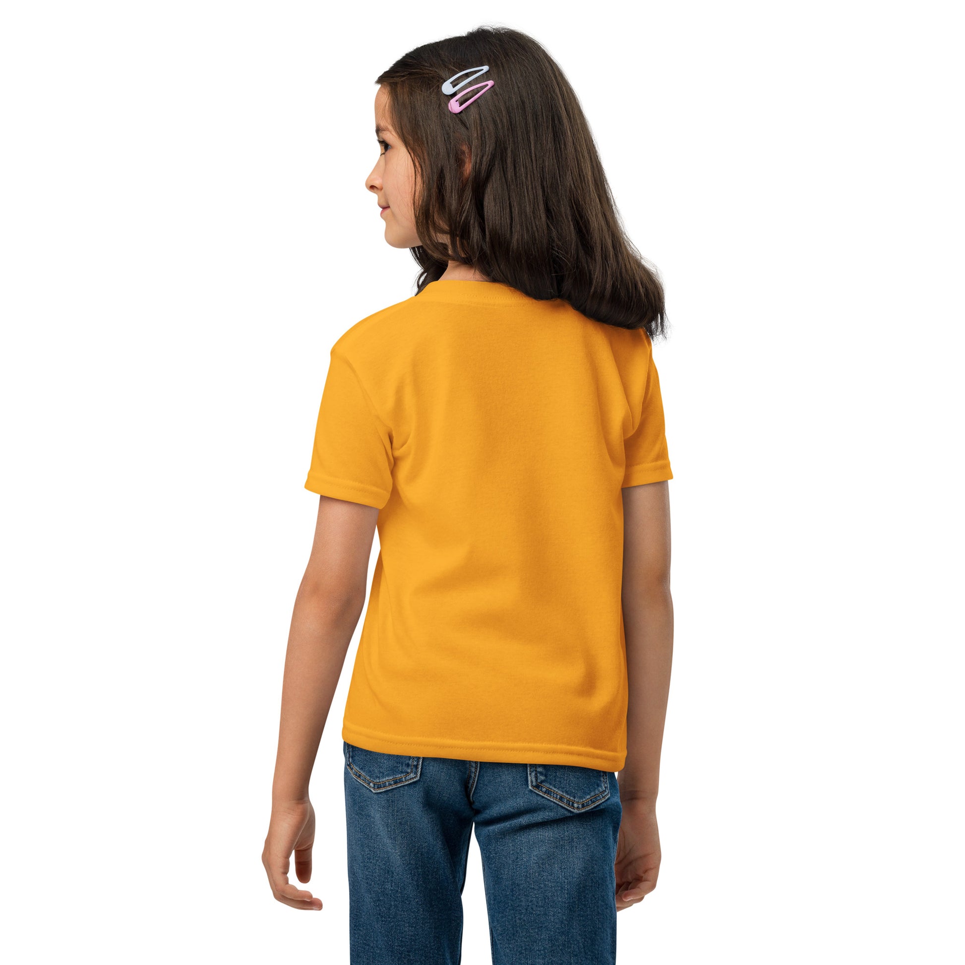 Child wearing a yellow t-shirt and blue jeans on a white background