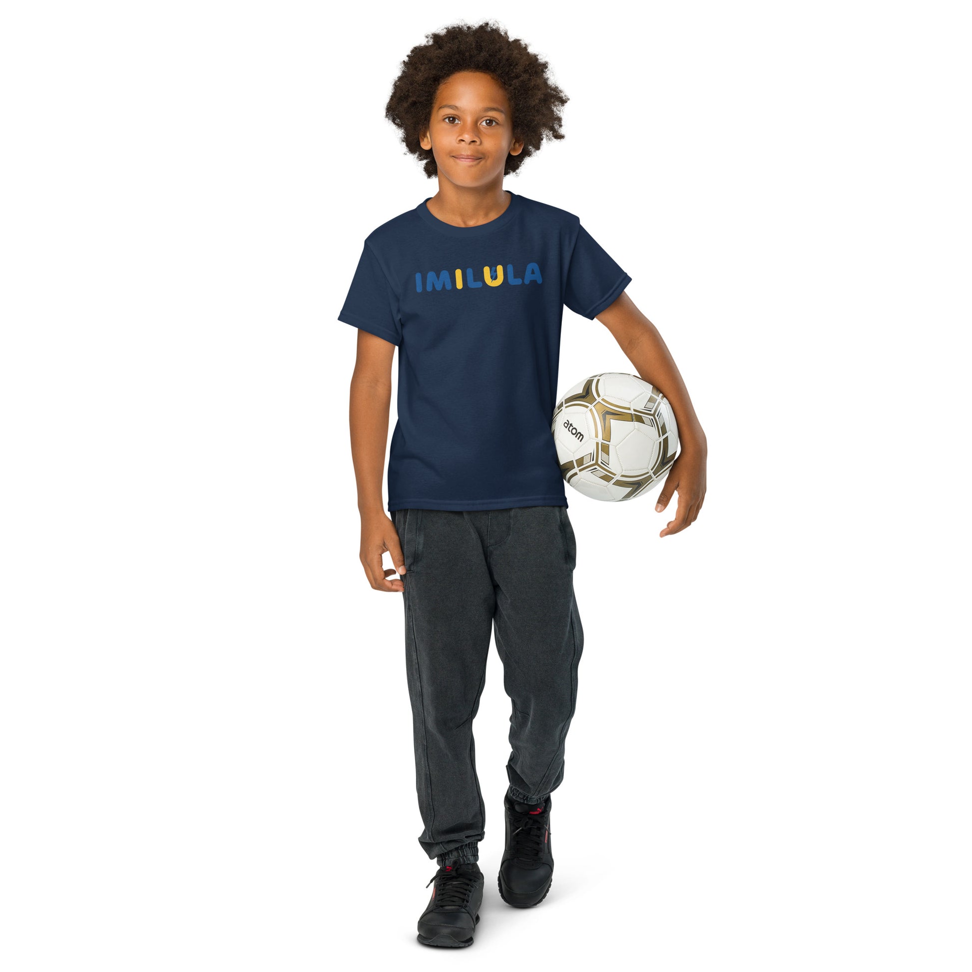 Child holding a soccer ball wearing a navy blue t-shirt with text on a white background