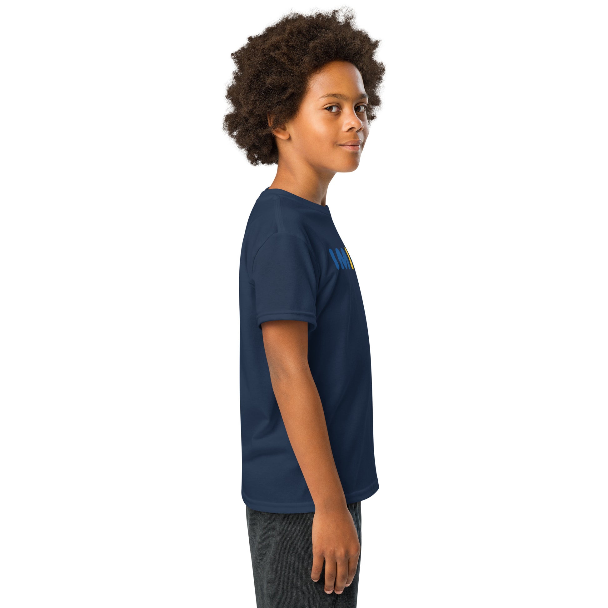 Child wearing a navy blue t-shirt with yellow graphics on a white background