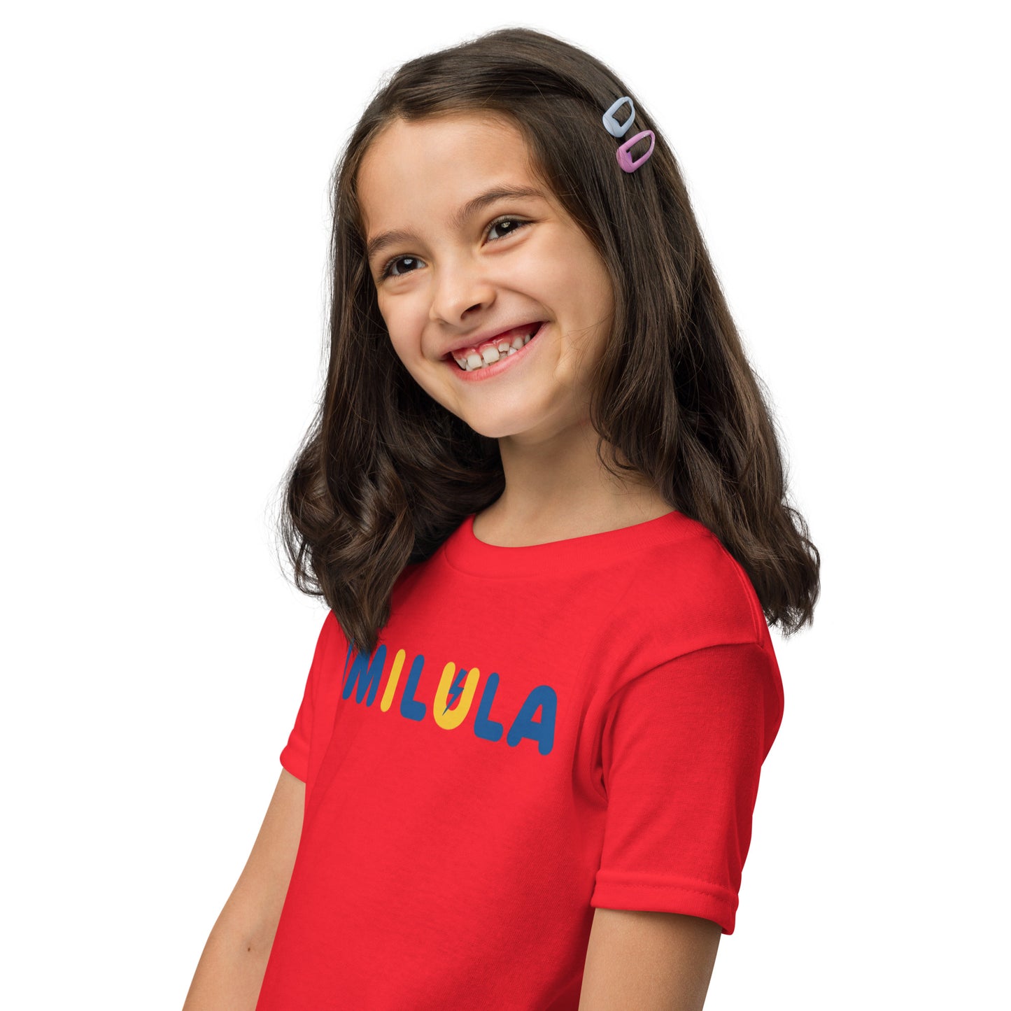 Young girl wearing a red shirt with colorful text on a white background