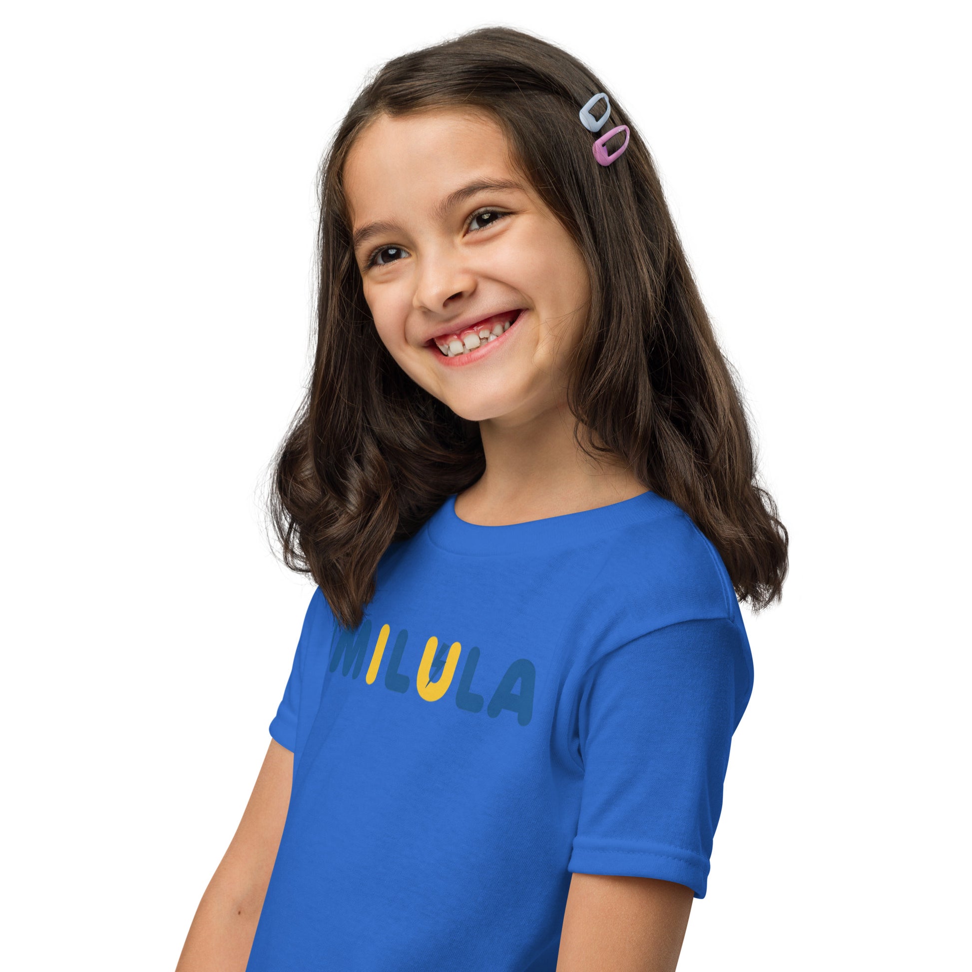 Young girl wearing a blue t-shirt with 'LULU' printed on it against a white background